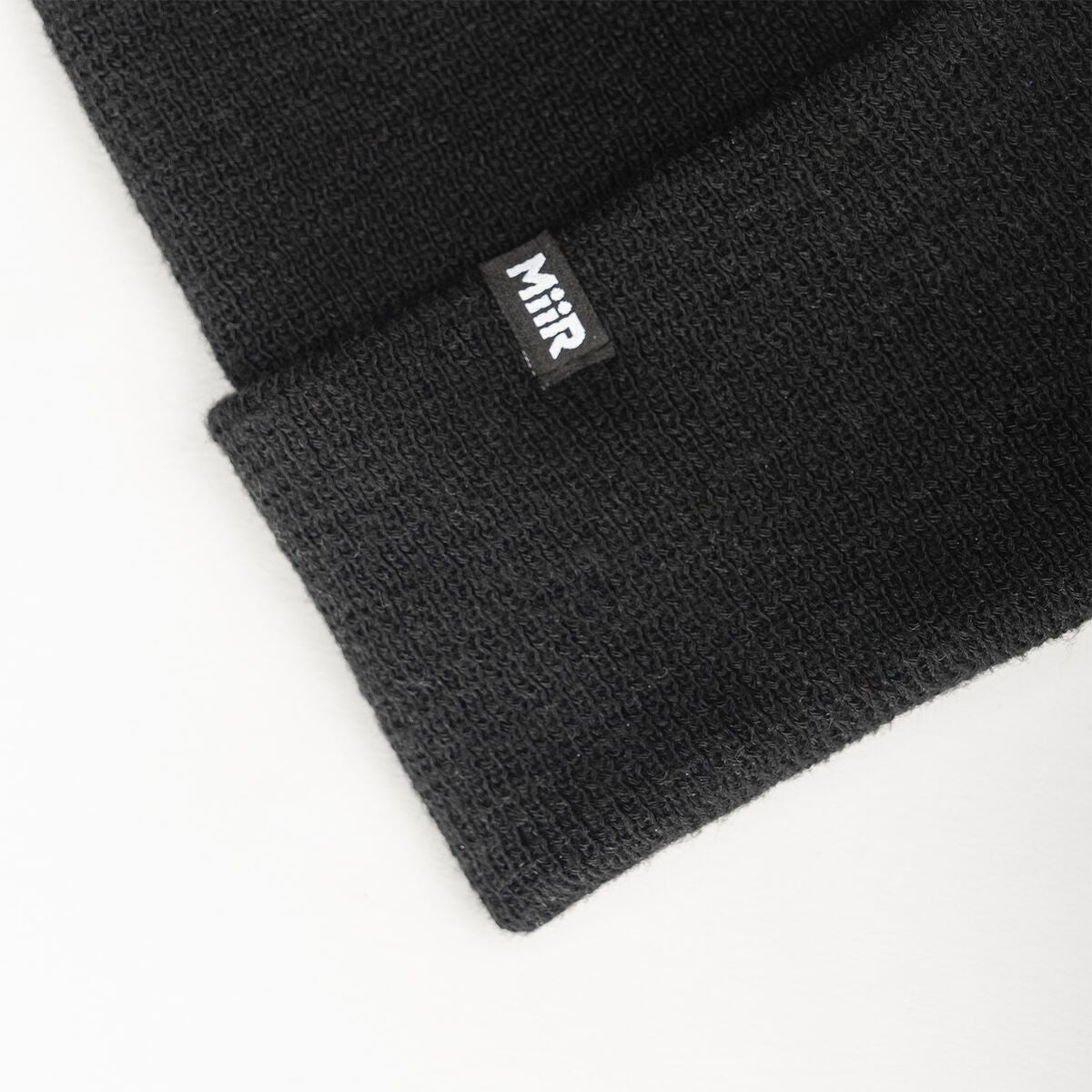 recycled-poly-fine-knit-beanie-m4 WebPDP-RecycledPolyFineKnitBeanie_Studio_TagDetail_Black__BNE005002OS.jpg